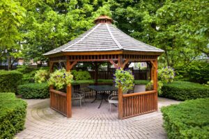 Wooden Gazebo Surrounded by Greenery in Backyard