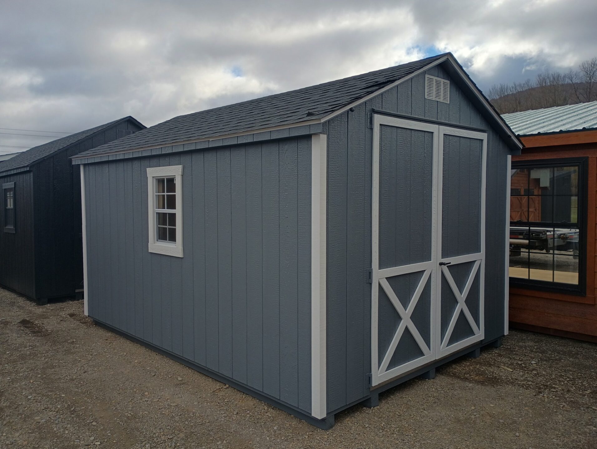 Small shed with double doors, two windows and shingled roof