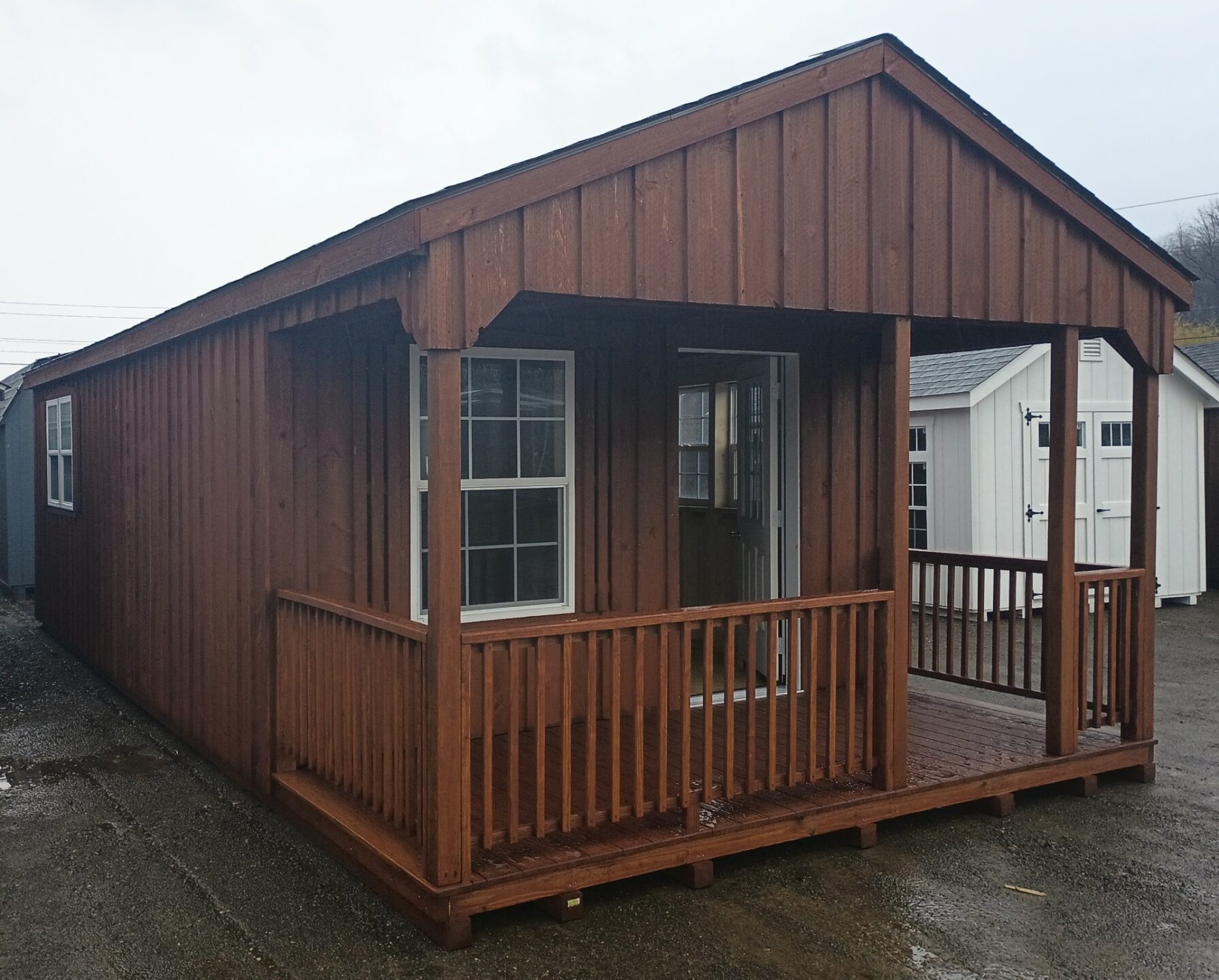 A Frame board & batten cabin with front door and 6' porch