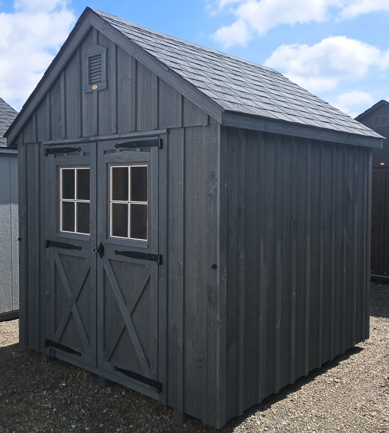 Small board and batten shed with double doors with windows