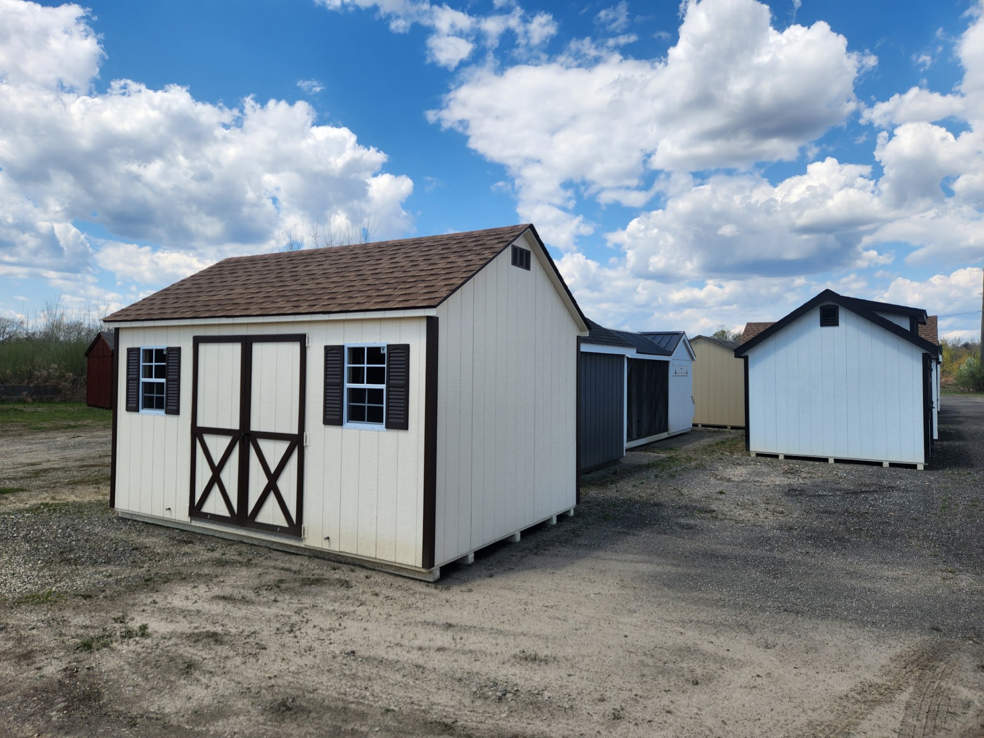 Navajo color shed with brown trim and double doors with two windows and shutters on long end