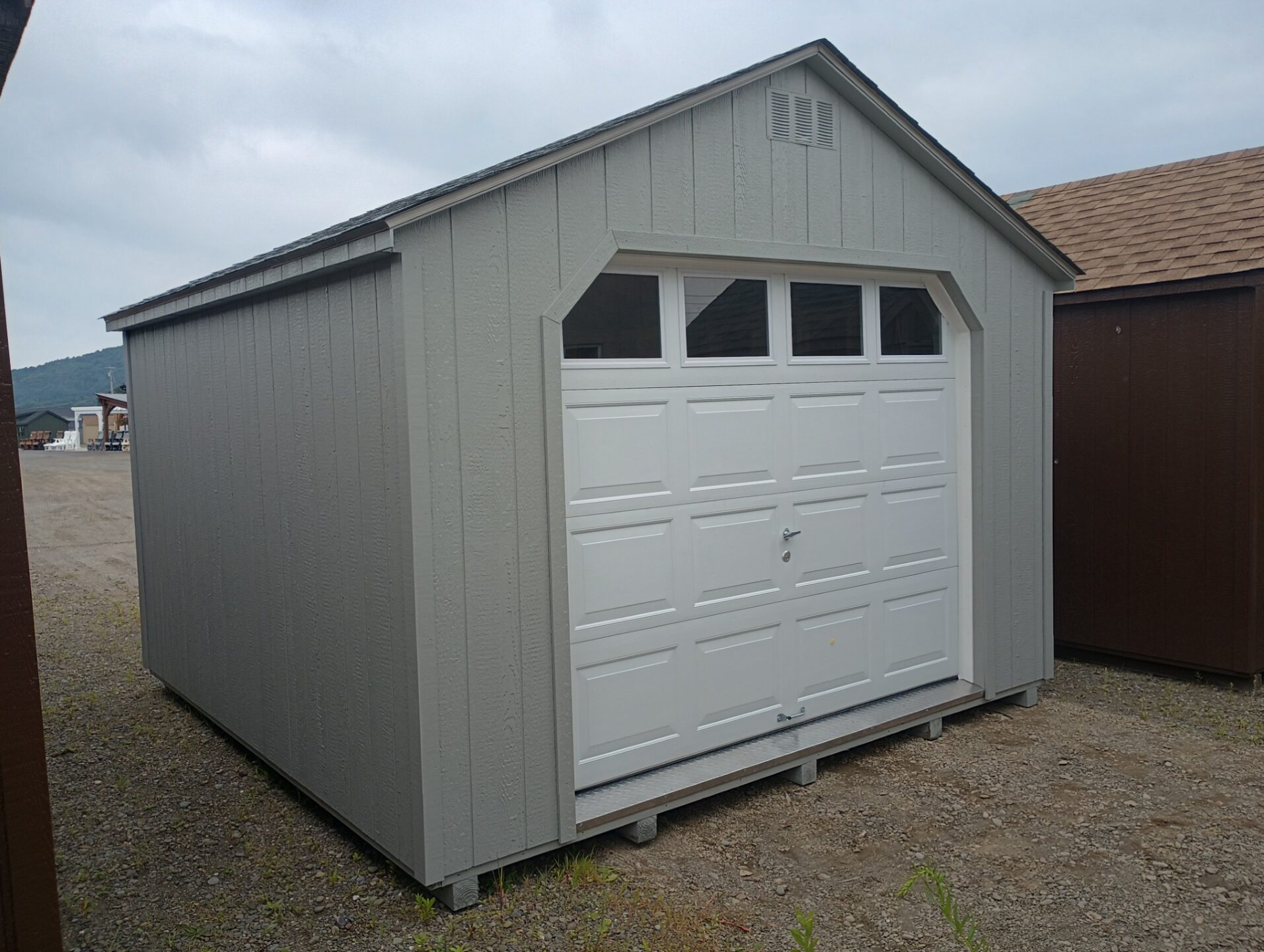 Small structure with garage door with top row of windows