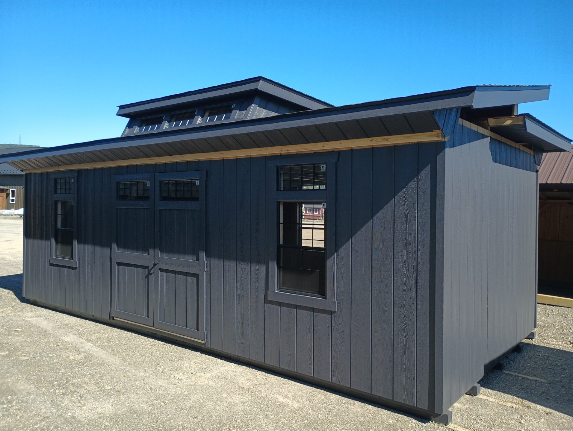 Hinged roof shed with transom dormer, double doors and two windows